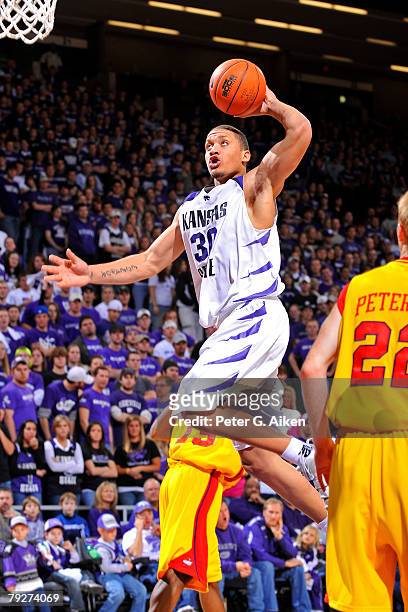Forward Michael Beasley of the Kansas State Wildcats drives to the basket in the second half against the Iowa State Cyclones during an NCAA...