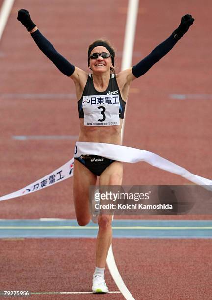 Mara Yamauchi of Great Britain celebrates as she crosses the finishing line to win during Osaka International Ladies Marathon at Nagai Stadium on...
