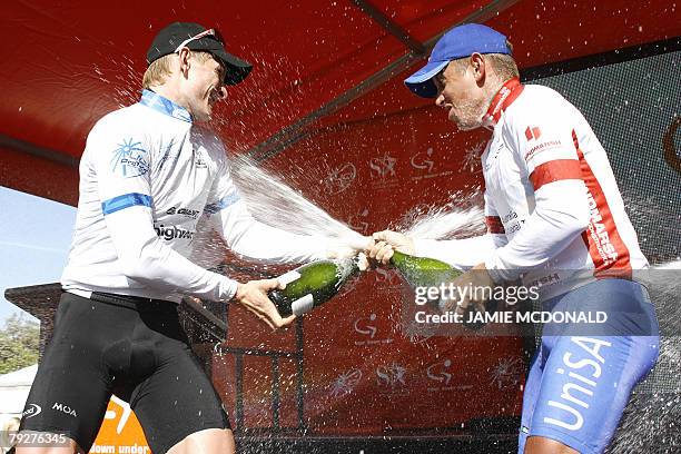 Winning rider German Andre Greipel of Team High Road and runner-up Australian Allan Davis shower each other with champagne after the final stage of...