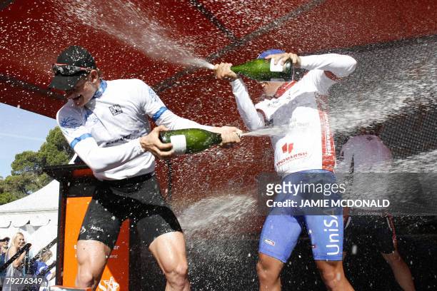 Winning rider German Andre Greipel of Team High Road and runner-up Australian Allan Davis shower each other with champagne after the final stage of...