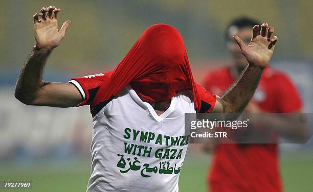 Egyptian player Mohamed Abou Traika wears a tee shirt reading "Sympathize with Gaza" as he celebrates his goal 1-0 against Sudan in Kumasi 26 January...