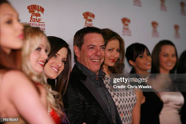 Restauranteur Dennis Riese, center, and Penthouse Pets attend the grand opening of the Hawaiian Tropic Zone at the Planet Hollywood Resort and Casino...