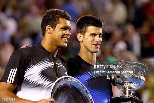 Jo-Wilfried Tsonga of France and Novak Djokovic of Serbia pose for photographers with their trophies after the men's final match against Jo-Wilfried...