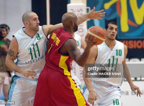 Jordan's Zain player Nate Johnson vies for the ball with Lebanon's al-Riyadi players Fadi al-Khatib and Ismail Ahmed during the 19th Dubai...