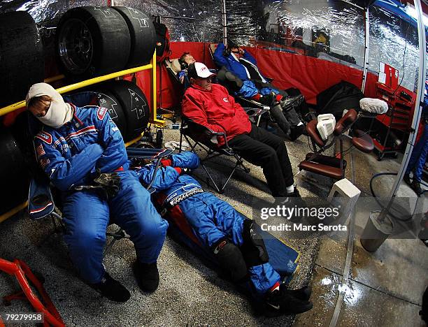 Crew members of the Porshe Riley Brumos Porshe racing team sleep on pit row during the Rolex 24 on January 26, 2008 at Daytona International Speedway...