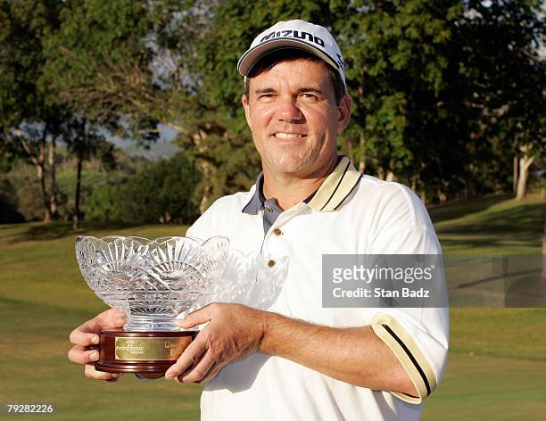 Scott Dunlap holds the winner's trophy following the fourth round of the Movistar Panama Championship at Club de Golf de Panama January 27, 2008 in...