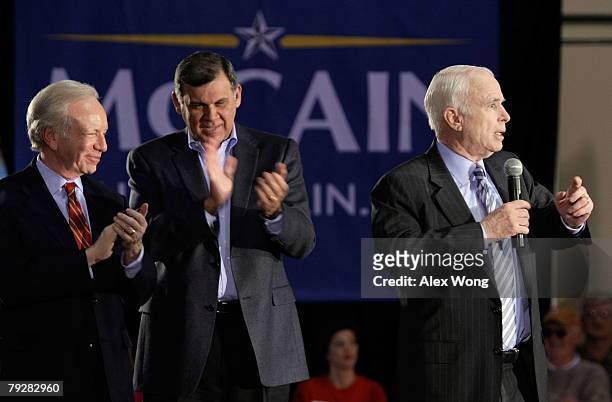 Sen. Joe Lieberman claps with Sen. Mel Martinez as they campaigns for Republican presidential hopeful Sen. John McCain while he speaks during a town...