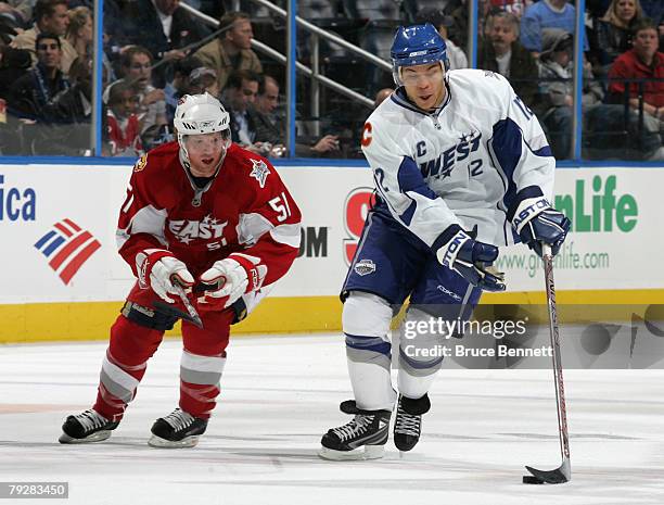 Western Conference All-Star Jarome Iginla of the Calgary Flames moves the puck on Brian Campbell of the Buffalo Sabres during the 56th NHL All-Star...