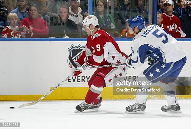 Eastern Conference All-Star Jason Spezza of the Ottawa Senators moves the puck against Nicklas Lidstrom of the Detroit Red Wings during the 56th NHL...