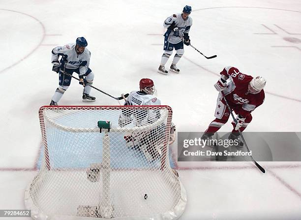 Eastern Conference All-Star Andrei Markov of the Montreal Canadiens scores a goal against goaltender Chris Osgood of the Detroit Red Wings during the...