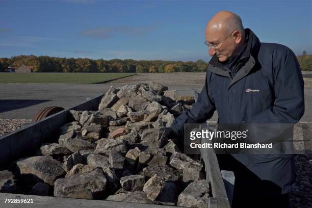 English historian and Holocaust specialist, David Cesarani standing by a quarry cart filled with rocks at the site of the former Buchenwald German...