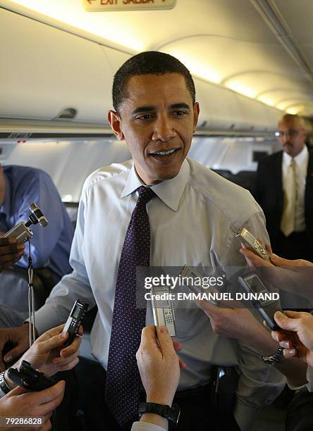 Democratic presidential candidate Illinois Senator Barack Obama speaks to reporters travelling with him aboard a plane bewteem Macon, Georgia, and...