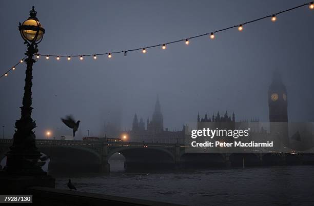 Parliament, Westminster Bridge and the River Thames are enveloped in fog on January 28, 2008 in London.