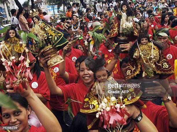 Wooden images of the Child Jesus are displayed in a parade during the Sto. Ni?o festival in Manila, 27 January 2008. Roman Catholics in the...