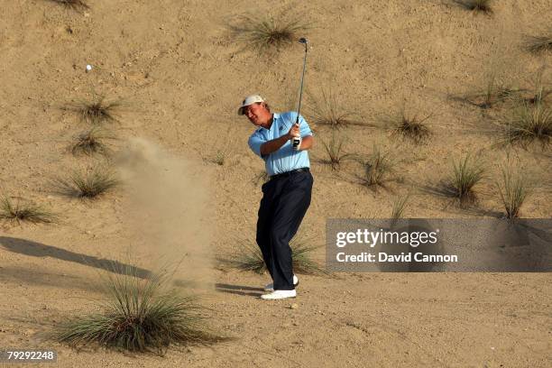 Ernie Els of South Africa plays his second shot at the par 3 17th hole during the opening day of the Els Course at Dubai Sports City on January 28,...