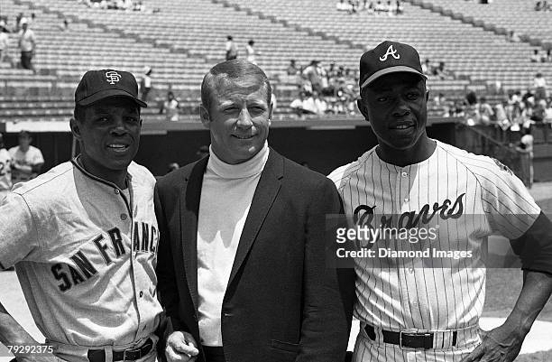 Outfielder Willie Mays of the San Francisco Giants, NBC television announcer Mickey Mantle and outfielder Hank Aaron of the Atlanta Braves pose for a...