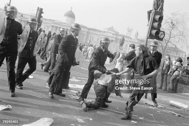 Police arrest a rioter in Trafalgar Square during violence, which arose from a demonstration against the Poll Tax, London, 31st March 1990.