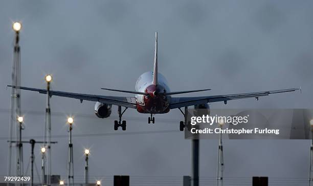 Passenger aircraft landing at Manchester International Airport approaches the runway on 28 January Manchester, England. Baggage handlers at the...