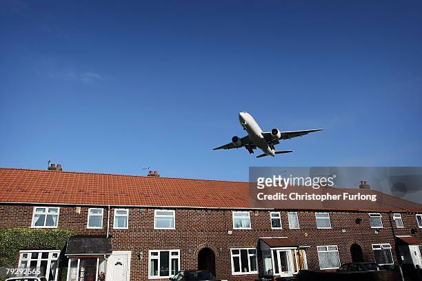 Passenger aircraft landing at Manchester International Airport approaches the runway on 28 January Manchester, England. Baggage handlers at the...