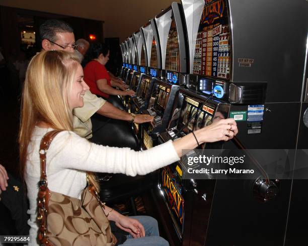 Woman plays a Vegas style slot machine in the Seminole Casino at the Seminole Hard Rock Hotel and Casino on January 28, 2008 in Hollywood Florida.