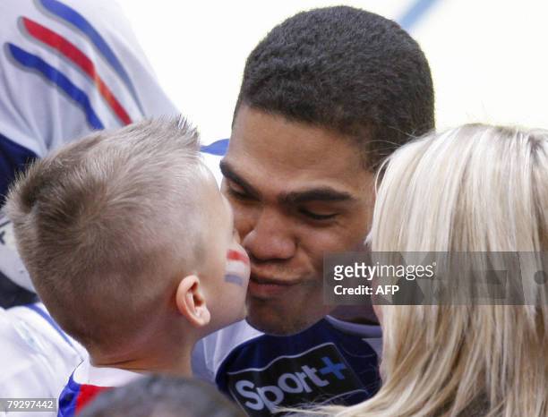 France's middle back Daniel Narcisse kisses his son at the end of their 8th Men's European Handball Championship Final match for the 3rd and 4th...