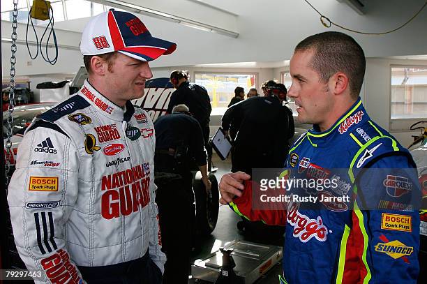 Dale Earnhardt Jr., driver of the Mountain Dew AMP/National Guard Chevrolet speaks with teammate Casey Mears, driver of the Kelloggs Chevrolet in the...