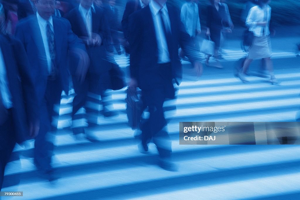 Business people crossing at the crosswalk, toned image, blurred motion, Tokyo, Japan