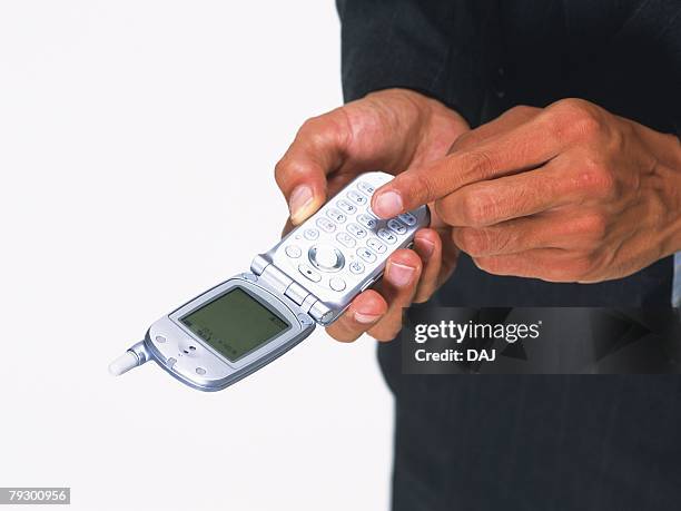 businessman pushing buttons of mobile phone, high angle view - male belly button stock pictures, royalty-free photos & images