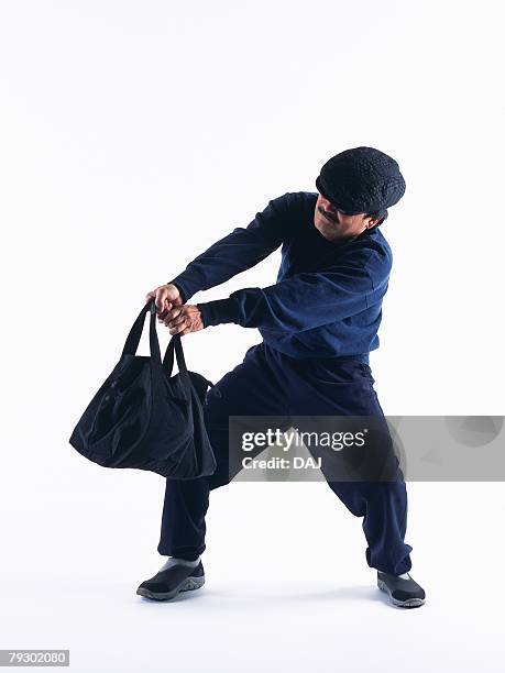 photography of a burglar trying to escape with a bag, front view - burglar carried stock pictures, royalty-free photos & images