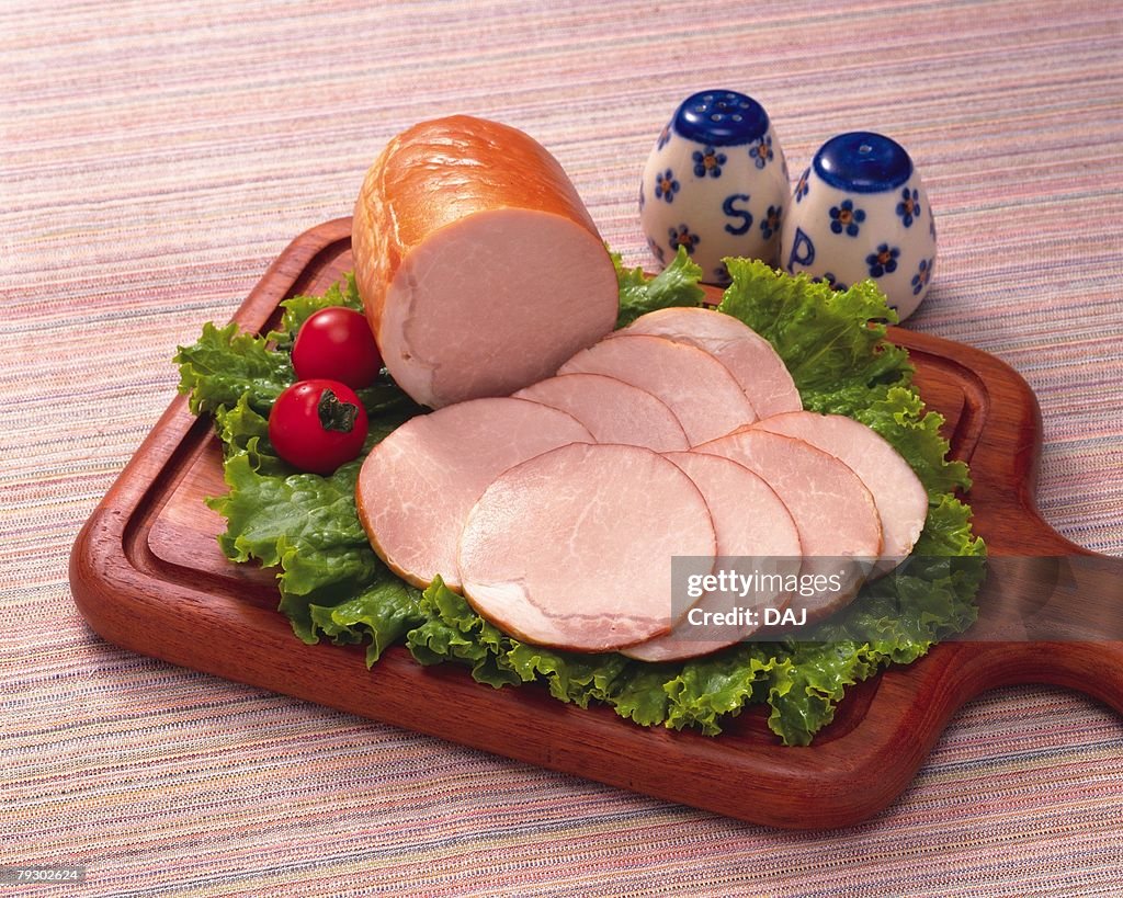 Sliced ham on lettuce, high angle view