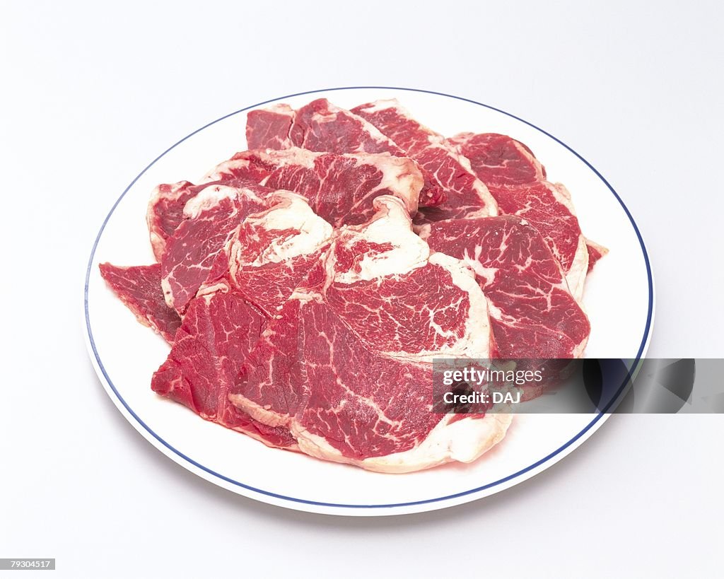 Raw beef on plate, high angle view