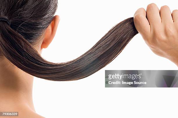 woman holding her hair - human hair stockfoto's en -beelden