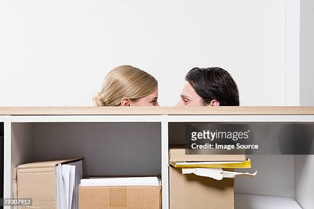 woman and man behind shelves - peeking over stock pictures, royalty-free photos & images