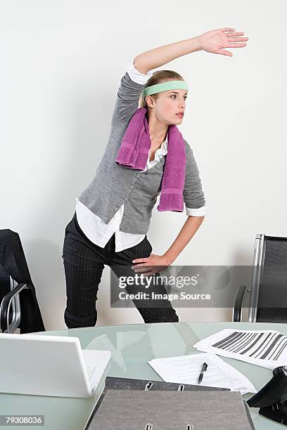 woman exercising in office - sweat band stock pictures, royalty-free photos & images