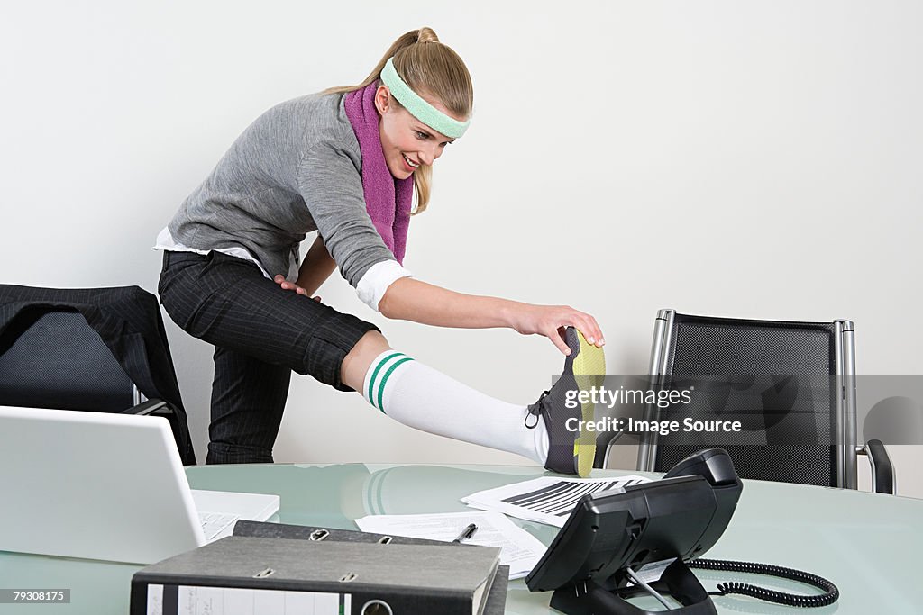 Office worker stretching her leg