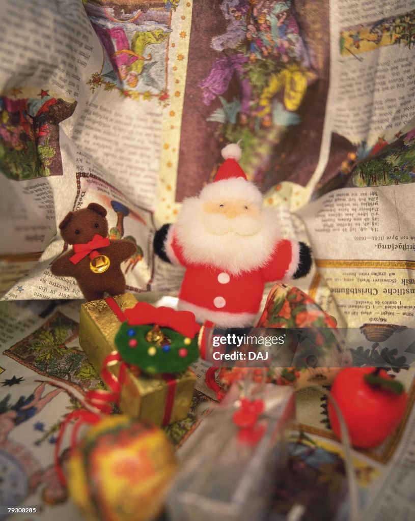 Christmas ornaments on newspaper, high angle view