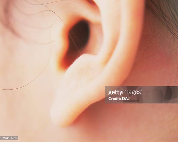 closed up image of an ear, side view, differential focus - earlobe ストックフォトと画像