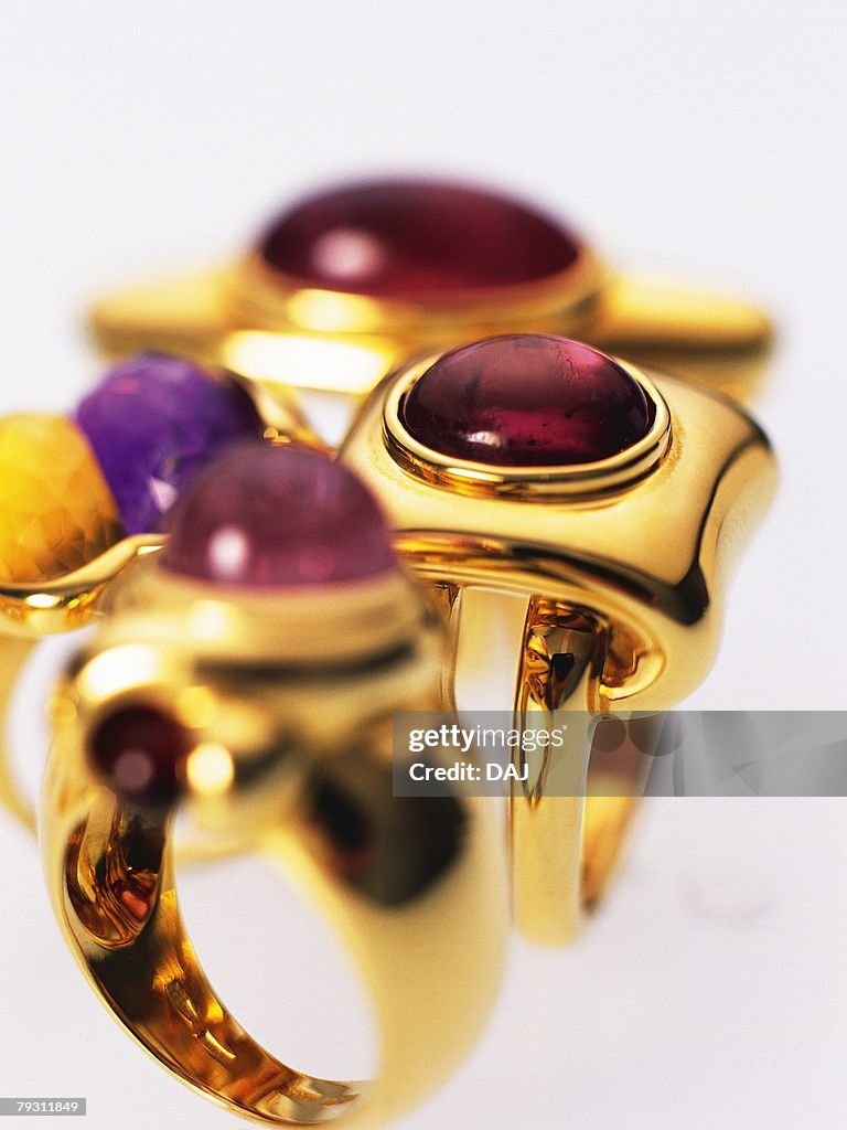 Four rings with jewels, high angle view, close up, white background