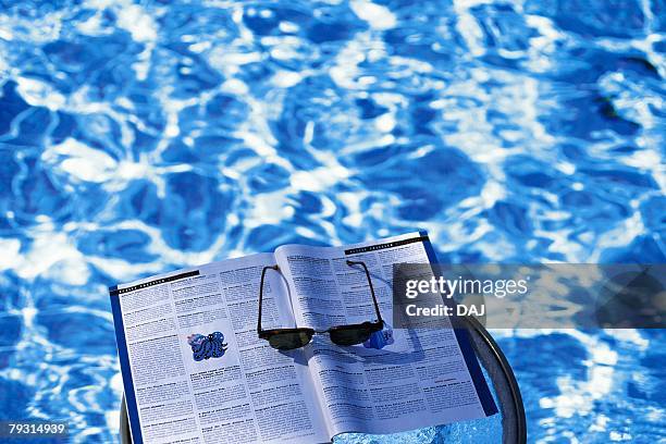 photography of sunglasses and a magazine floating on the water, high angle view - magazine retreat day 2 stock pictures, royalty-free photos & images