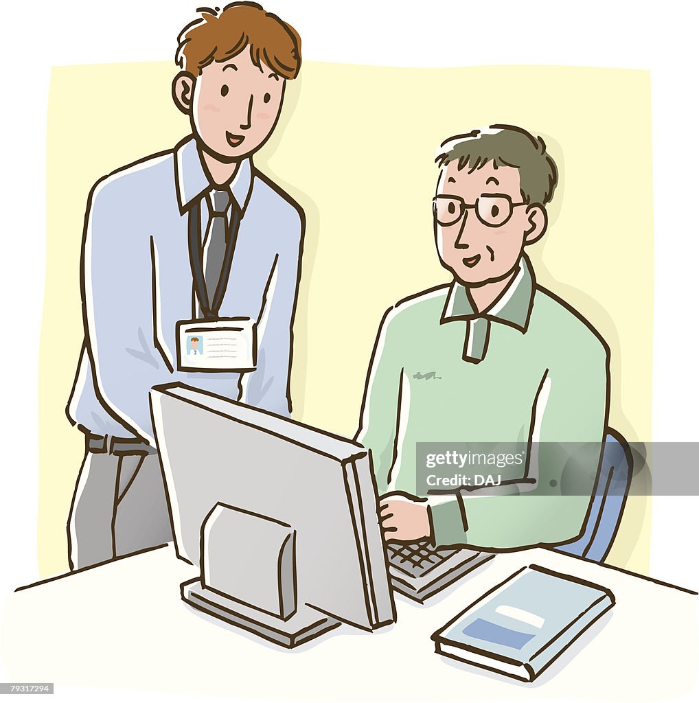 Man talking to mature man sitting at desk with computer, high angle view