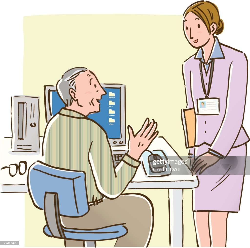 Senior man talking to woman standing beside his desk