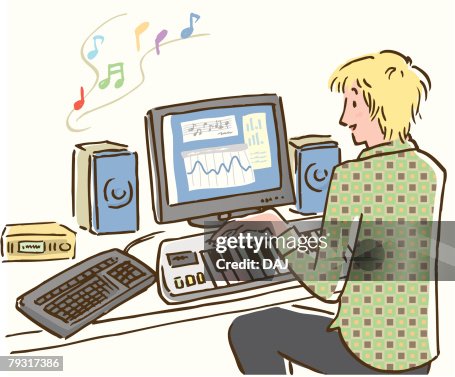 Man playing and making music using computer, rear view Man playing and making music using computer, rear view