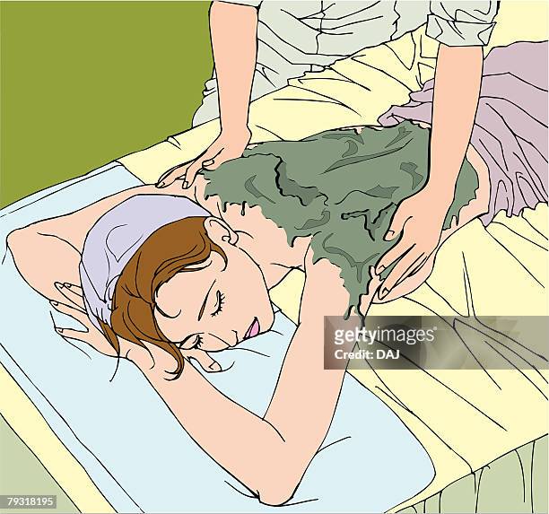woman taking mud treatment in beauty parlour, high angle view - mud therapy stock illustrations