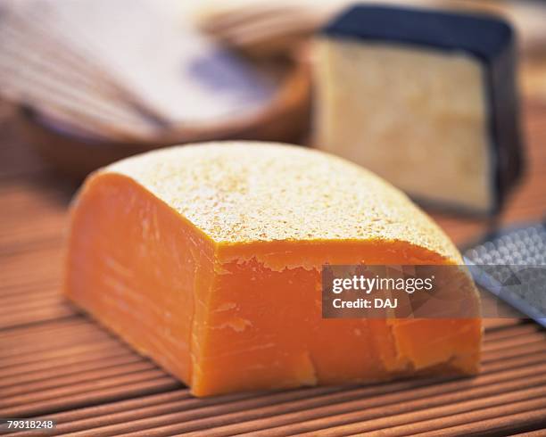 mimolette cheese, close up, differential focus - mimolette stock pictures, royalty-free photos & images