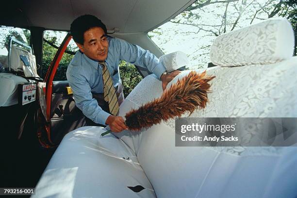japan,tokyo,taxi driver dusting interior of cab - dusting stock pictures, royalty-free photos & images