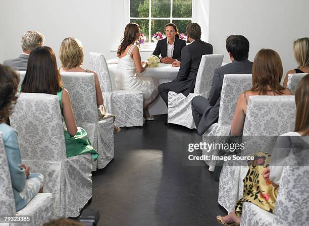 bride and groom with the registrar - wedding ceremony seats stock pictures, royalty-free photos & images
