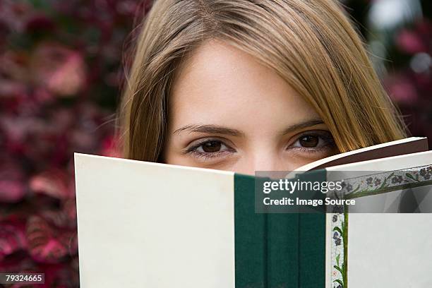 young woman with a book - cover book stock pictures, royalty-free photos & images