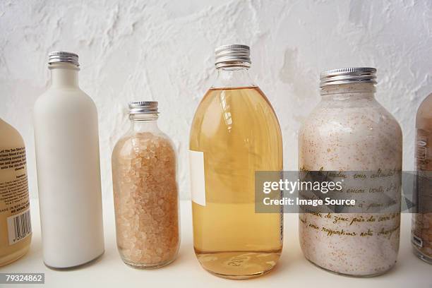 bottles of cosmetics in a row - bubble bath bottle stock pictures, royalty-free photos & images