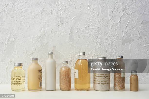 row of cosmetics bottles - bath salt stock pictures, royalty-free photos & images