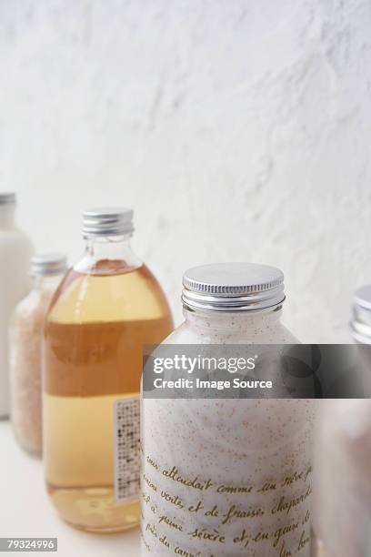 row of cosmetics bottles - bubble bath bottle stock pictures, royalty-free photos & images
